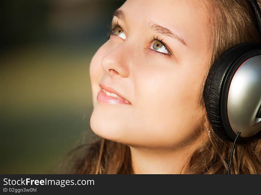 Beautiful happy woman listening to music