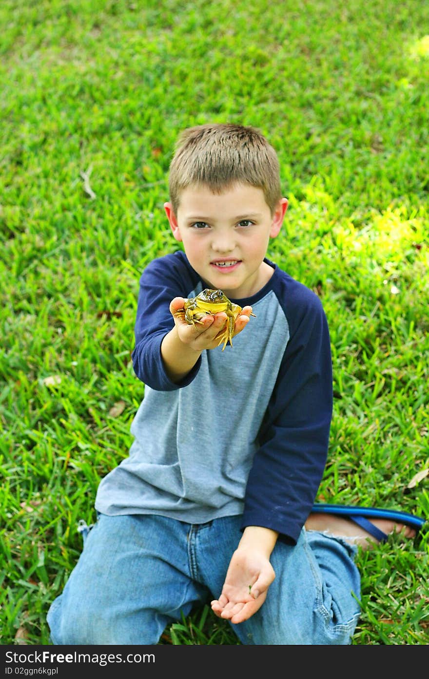 Shot of a cute little boy showing off his frog