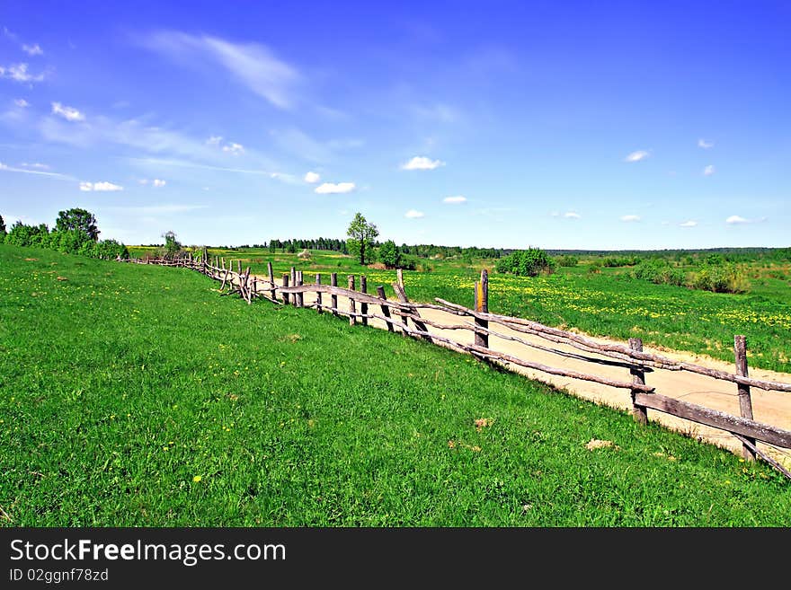 Old fence on field along road