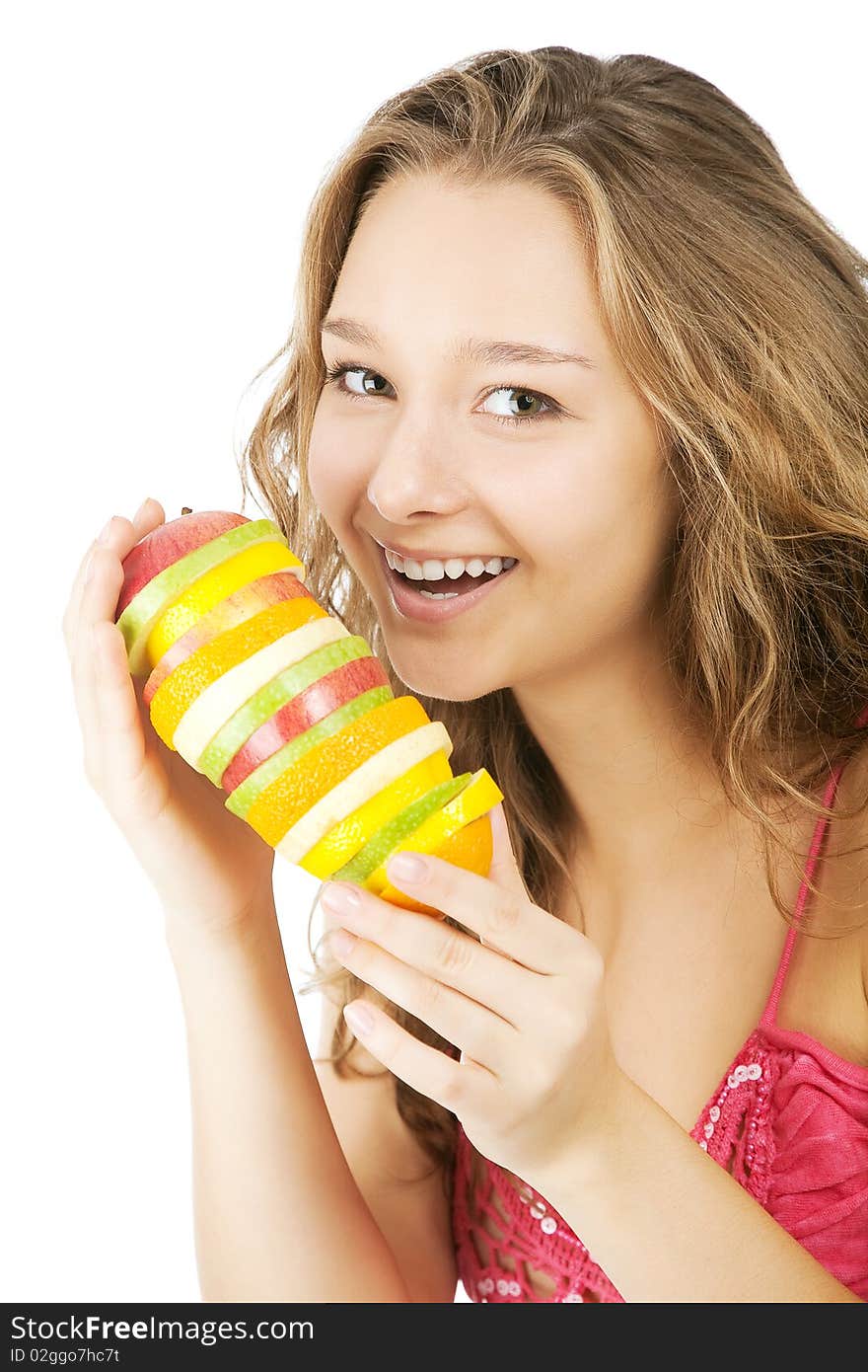 Portrait of happy young woman holding  mixed fruits over white background