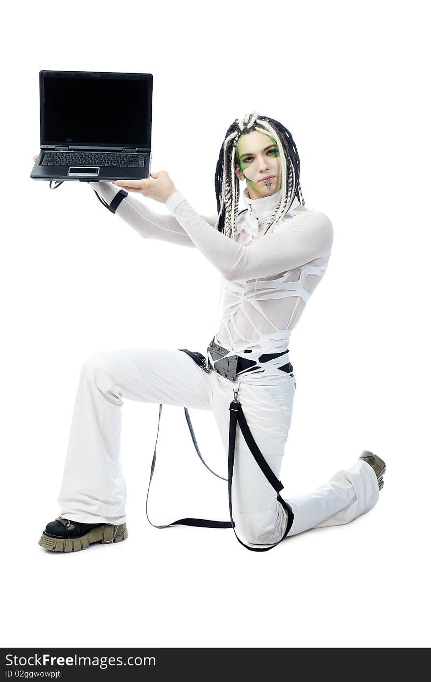 Shot of a futuristic young man with wires holding a laptop. Isolated over white background. Shot of a futuristic young man with wires holding a laptop. Isolated over white background.