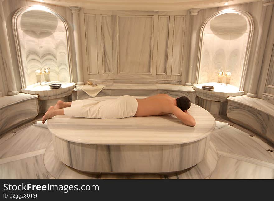 Portrait of a man lying in a room of a wellness centre