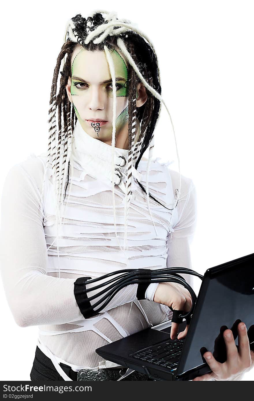 Shot of a futuristic young man with wires holding a laptop. Isolated over white background. Shot of a futuristic young man with wires holding a laptop. Isolated over white background.