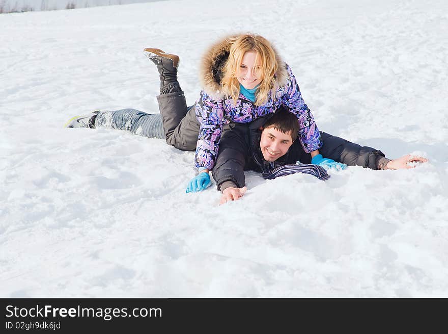 Young guy and the girl walk together in the winter. Young guy and the girl walk together in the winter