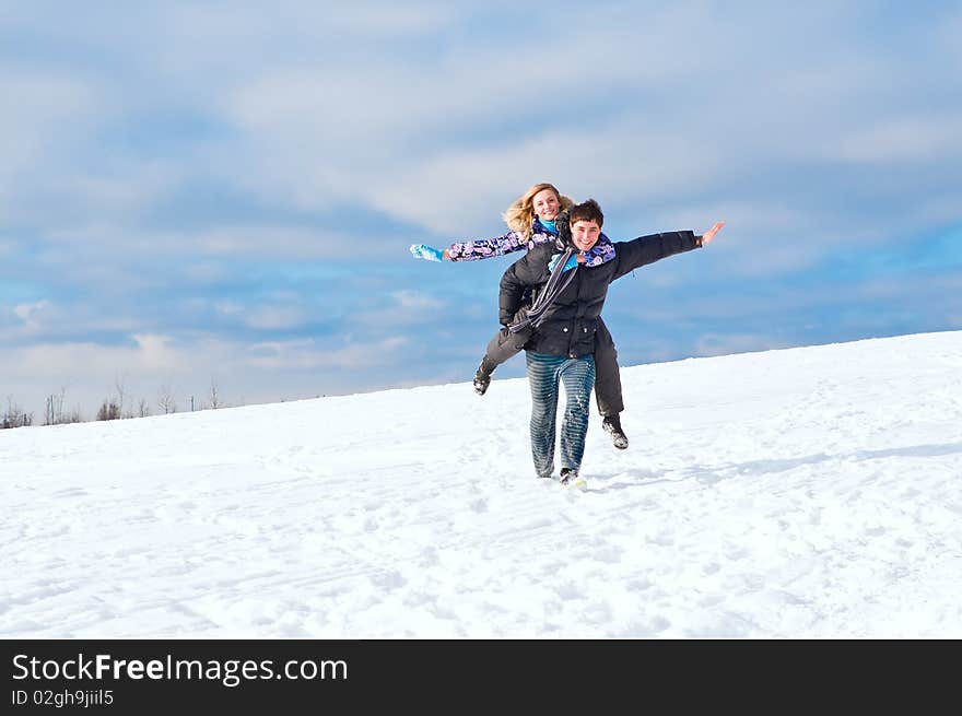 Young guy and the girl walk together in the winter. Young guy and the girl walk together in the winter