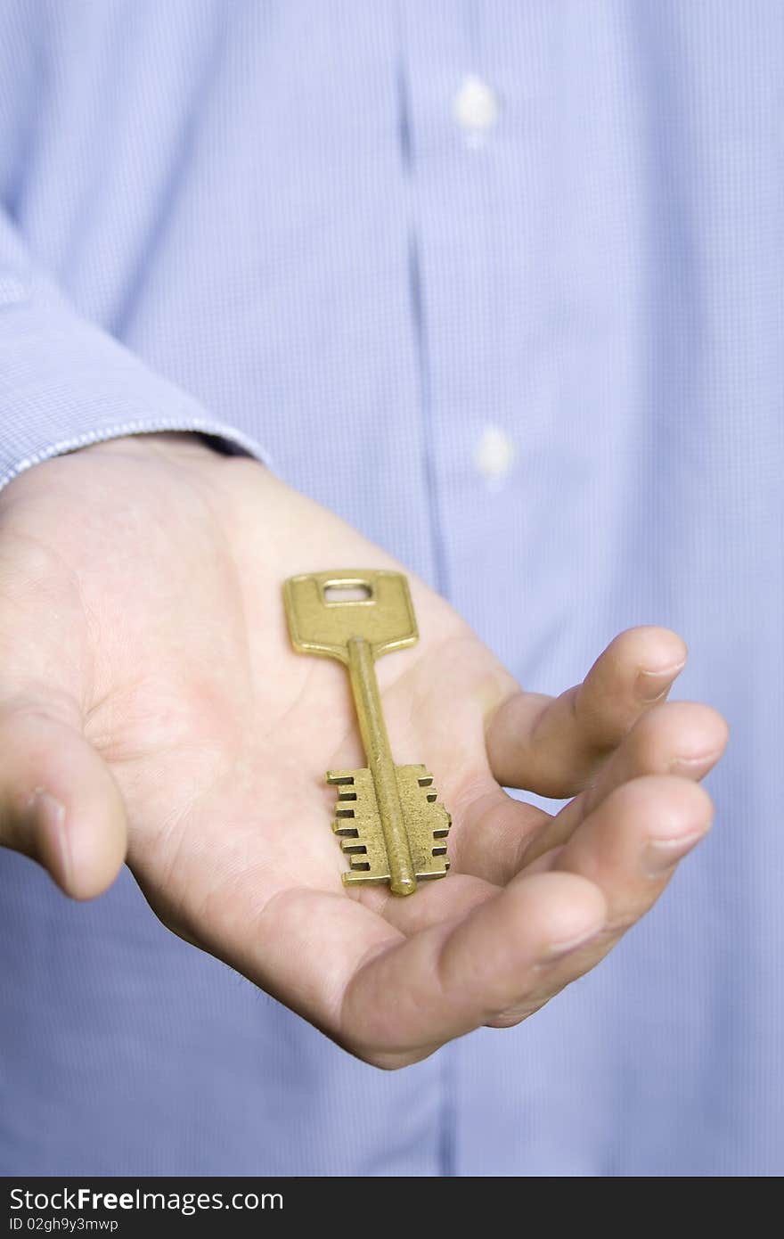 Keys to the house in the palm of a young man in a blue shirt. Keys to the house in the palm of a young man in a blue shirt