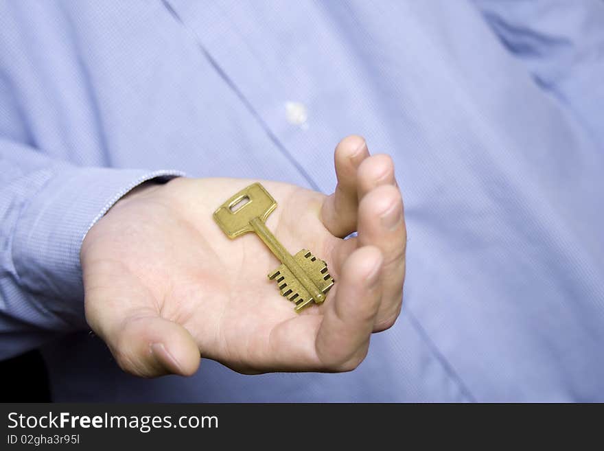 Keys to the house in the palm of a young man in a blue shirt. Keys to the house in the palm of a young man in a blue shirt