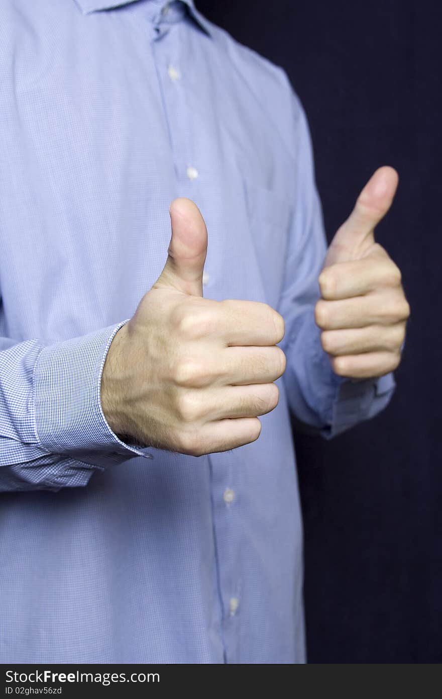 Happy young businessman in a blue shirt with a finger gesture OK. Happy young businessman in a blue shirt with a finger gesture OK