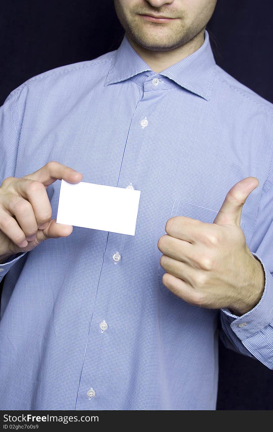 Business young man in a blue shirt holding a blank business card. Another hand the excitement thumb up. Business young man in a blue shirt holding a blank business card. Another hand the excitement thumb up