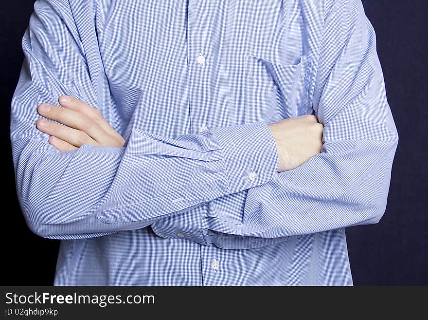 Posture. Young man in a blue shirt, hands folded one by one in the castle. Posture. Young man in a blue shirt, hands folded one by one in the castle