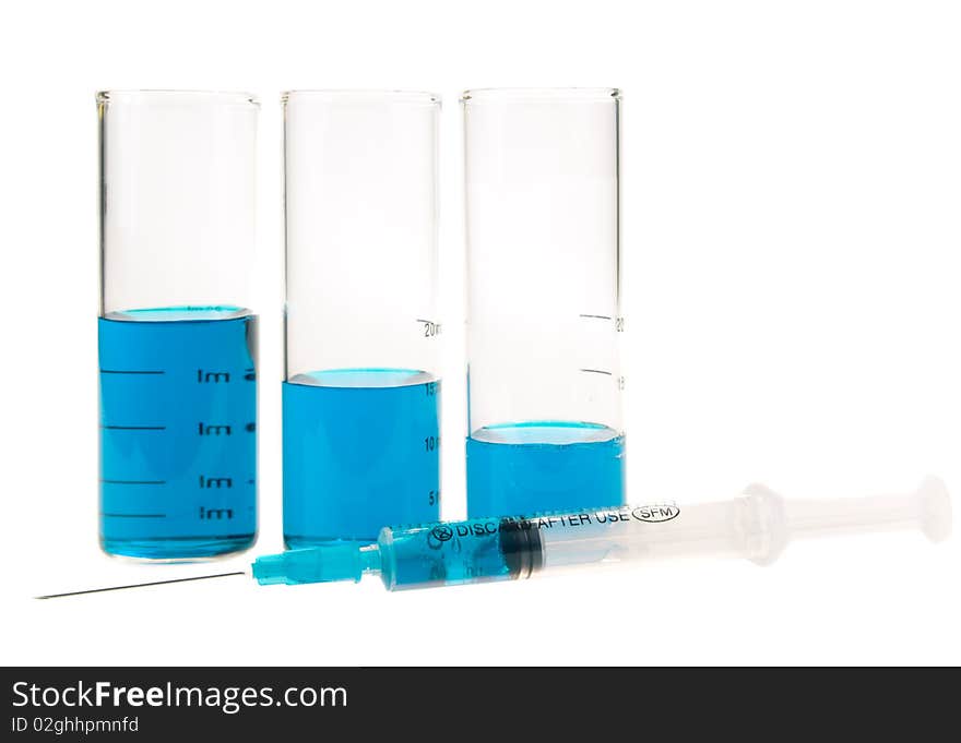 Tubes  and syringe with blue liquid on a white background. Tubes  and syringe with blue liquid on a white background