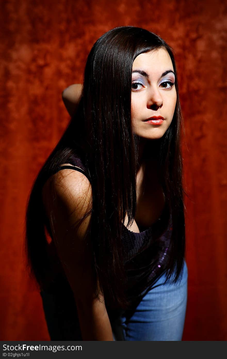 Young girl portrait on a red background