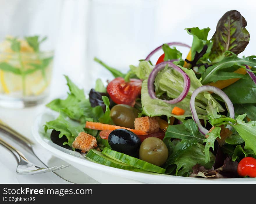 Closeup of mixed lettuce with black and green olive. Closeup of mixed lettuce with black and green olive