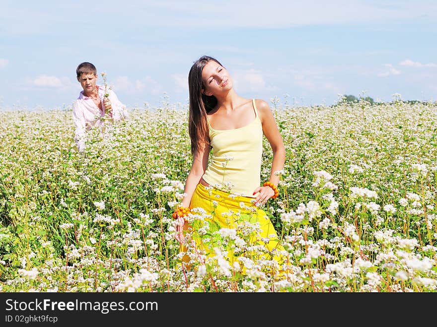 Young lovely couple on a flower field