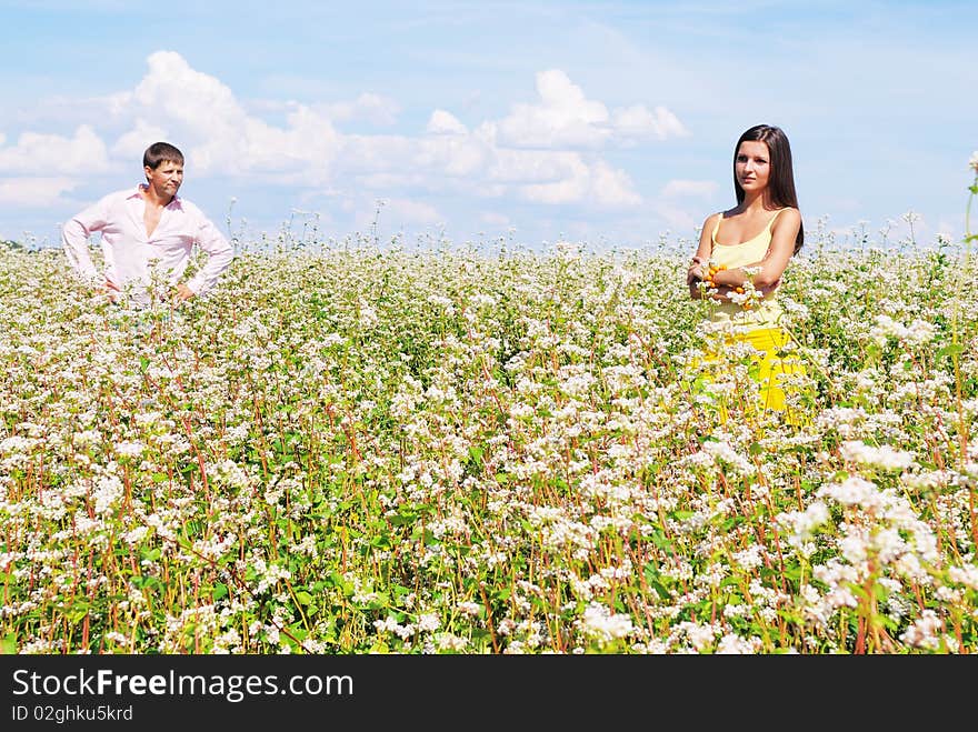 Young Lovely Couple On A Flower Field