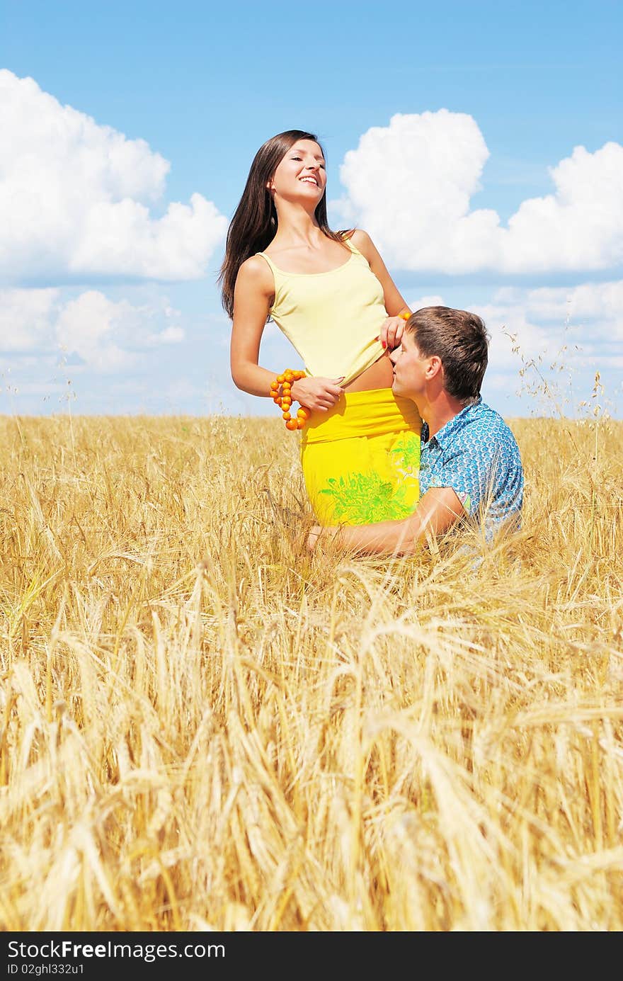 Young lovely couple on a flower field