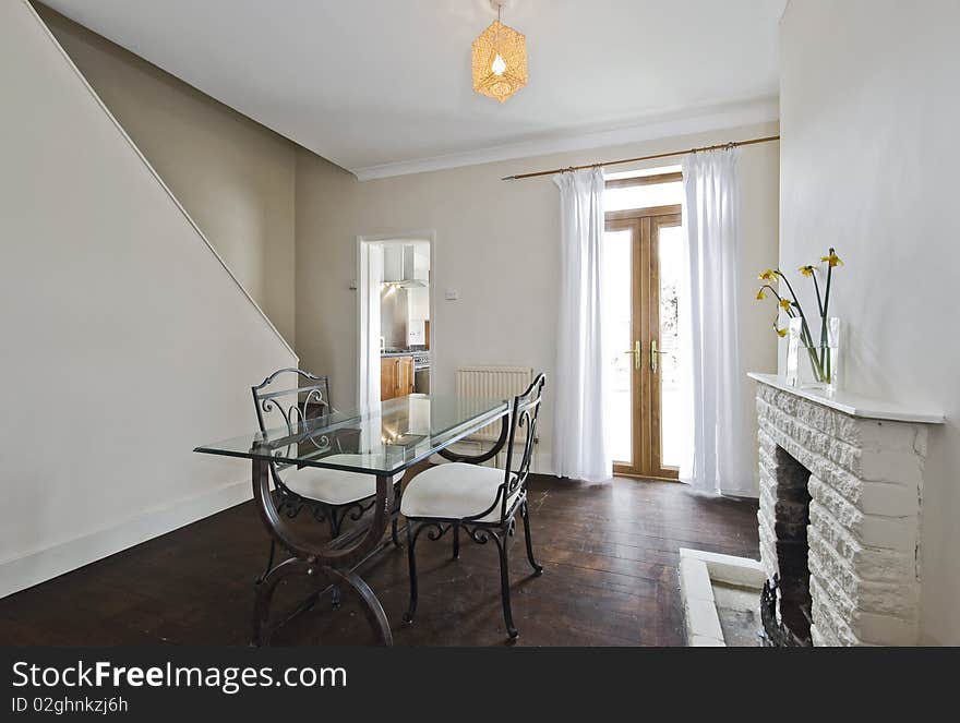 Dining room with vintage glass top dining table and fireplace