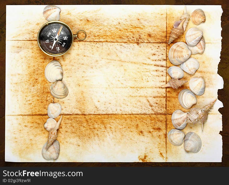 Compass and magnifier  on old textured paper with sea cockleshells. Compass and magnifier  on old textured paper with sea cockleshells