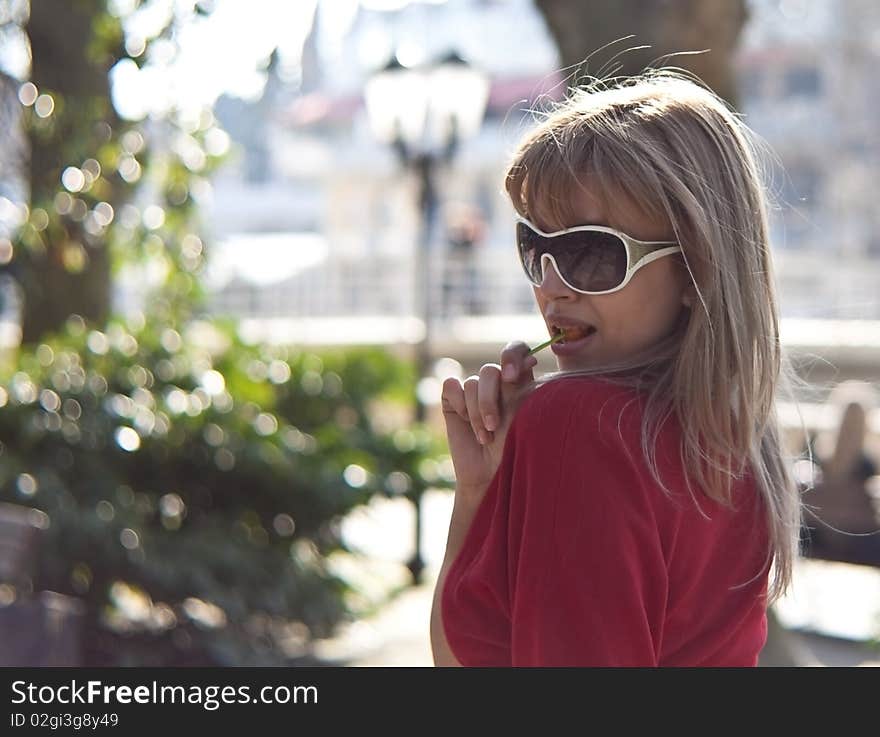 Beautiful woman with lollipop and glasses.