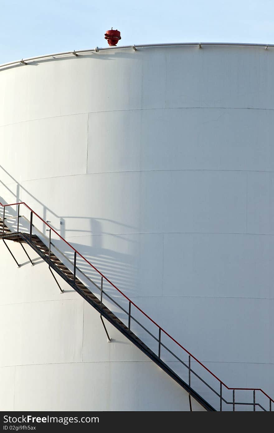 Industrial stair at white tank in tank farm. Industrial stair at white tank in tank farm