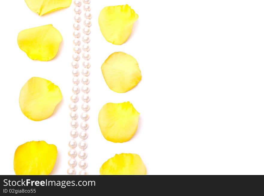 Yellow roses petals and white pearls isolated on white. Yellow roses petals and white pearls isolated on white