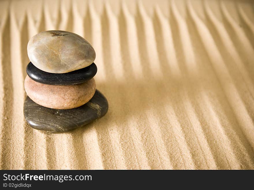 Coloured stones on brown sand