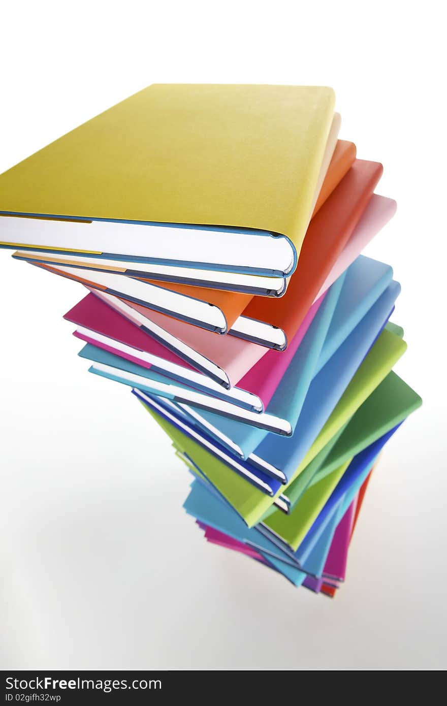 Pile of colorful real books on white background, side view. Pile of colorful real books on white background, side view.