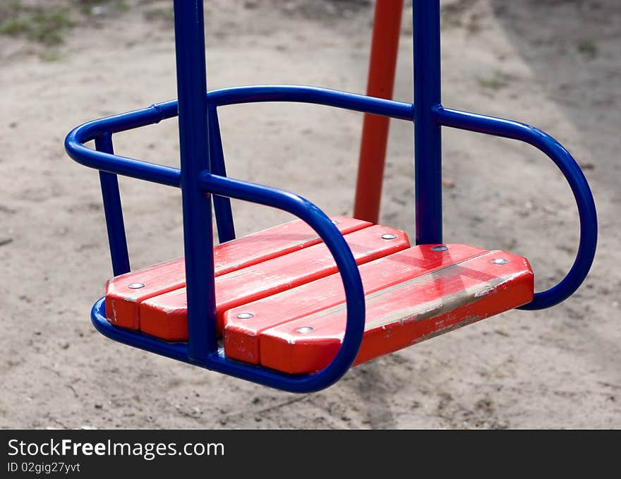 Empty swing of red color