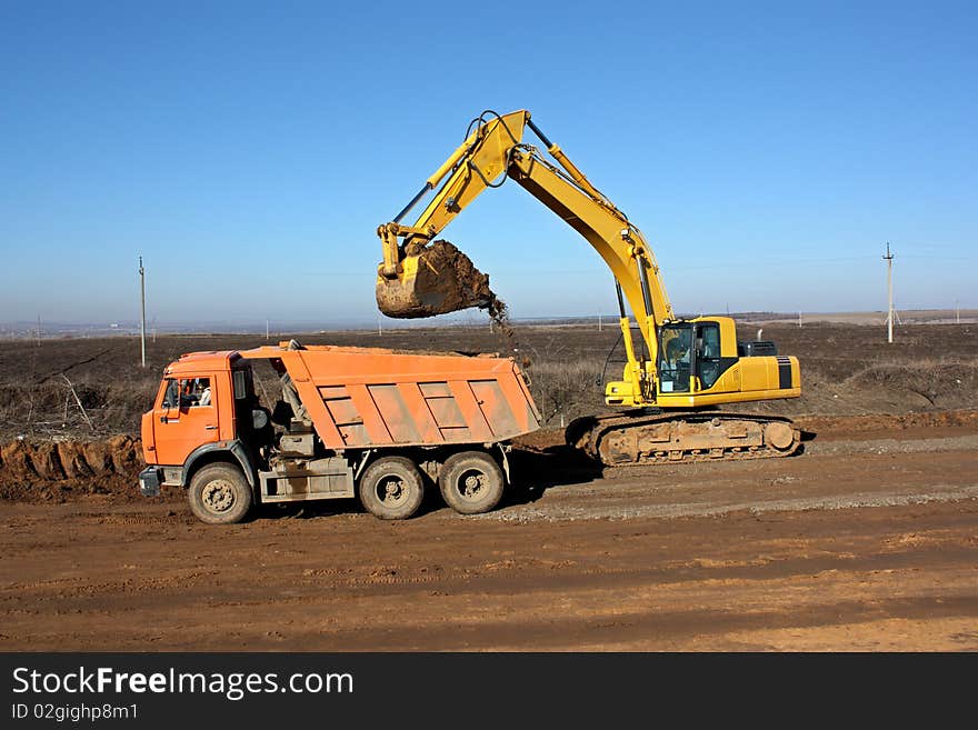 Dredge loads a ground in the truck. Dredge loads a ground in the truck