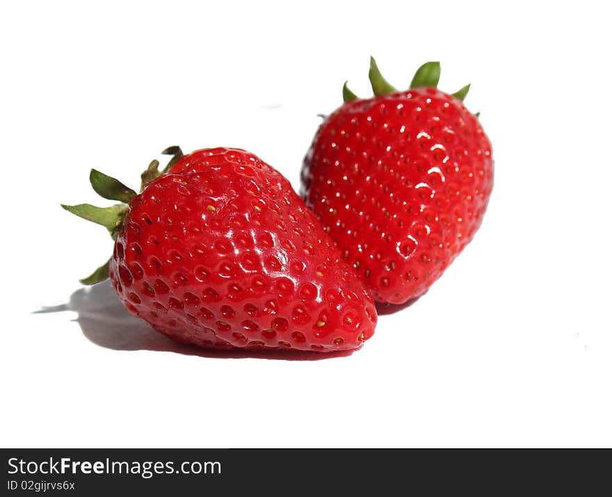 Still life with two strawberries on a white background