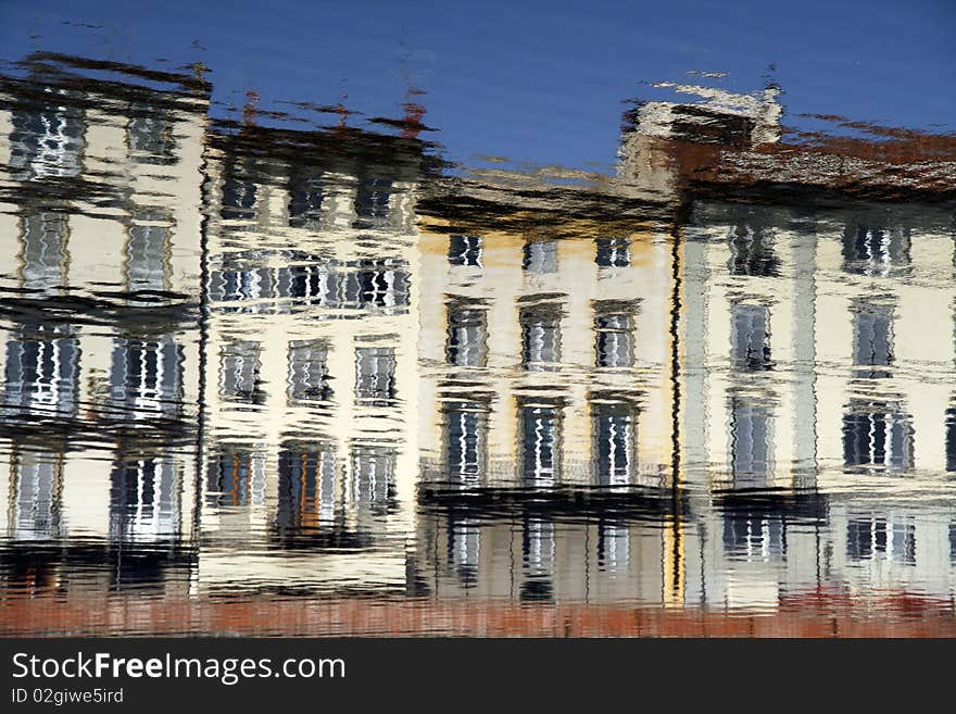 Water reflection of old tenements in Florence, Tuscany, Italy. Impressionistic style.