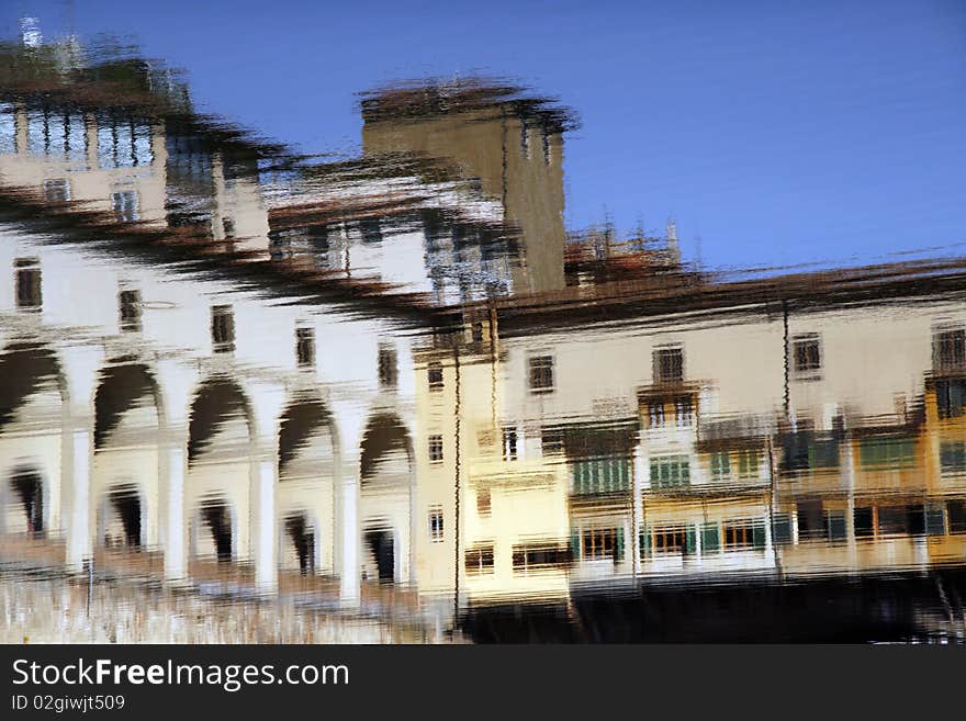 Water reflection of old bridge Ponte Vecchio in Florence, Tuscany, Italy. Impressionistic style.