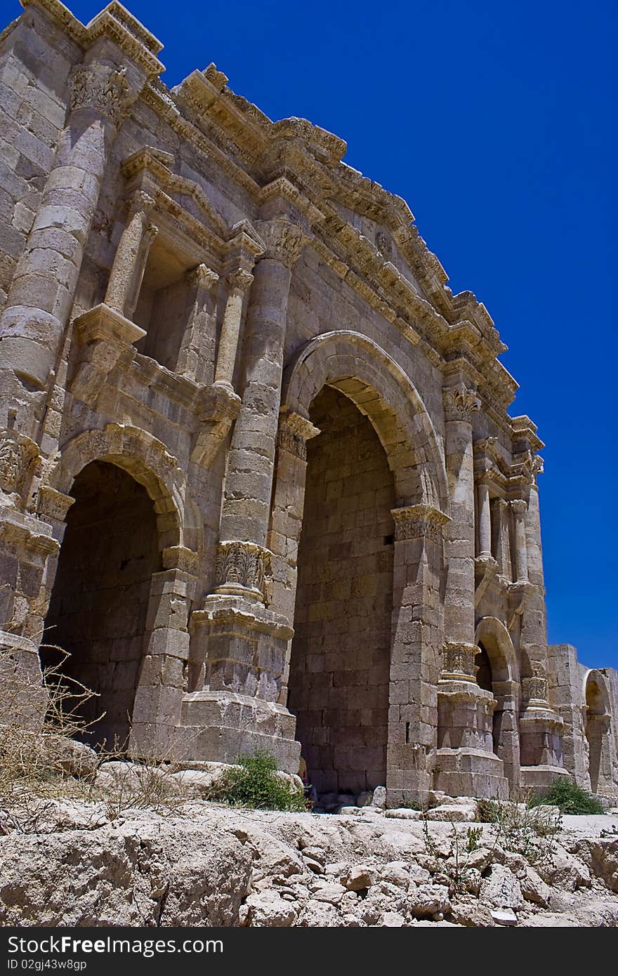 Photo of the Arch of Victory in Jerash - Jordan, taken in a bright sunny day over a blue sky