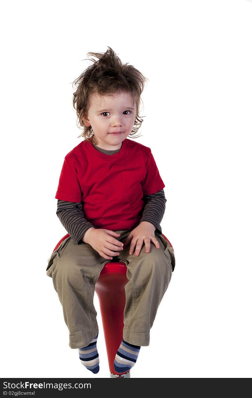 Cute boy sitting on a chair