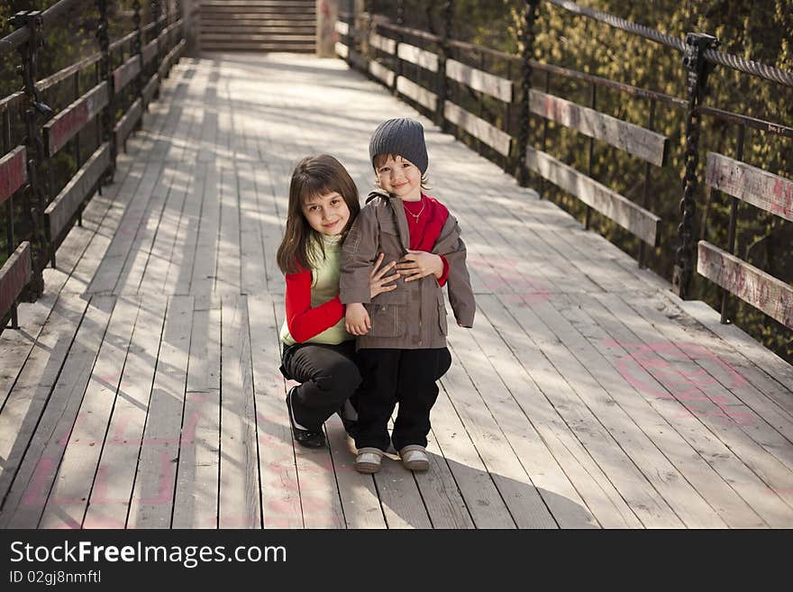 Couple of cute boy and girl on a bridge. Couple of cute boy and girl on a bridge