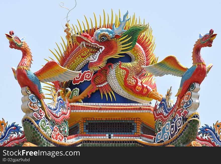 A chinese dragon with two phoenix