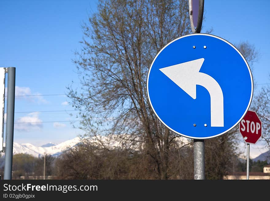 Road sign on mountain and tree background