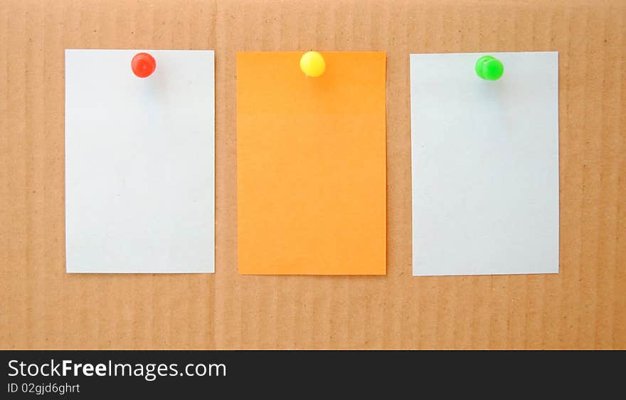 Colorful empty notes over brown cardboard