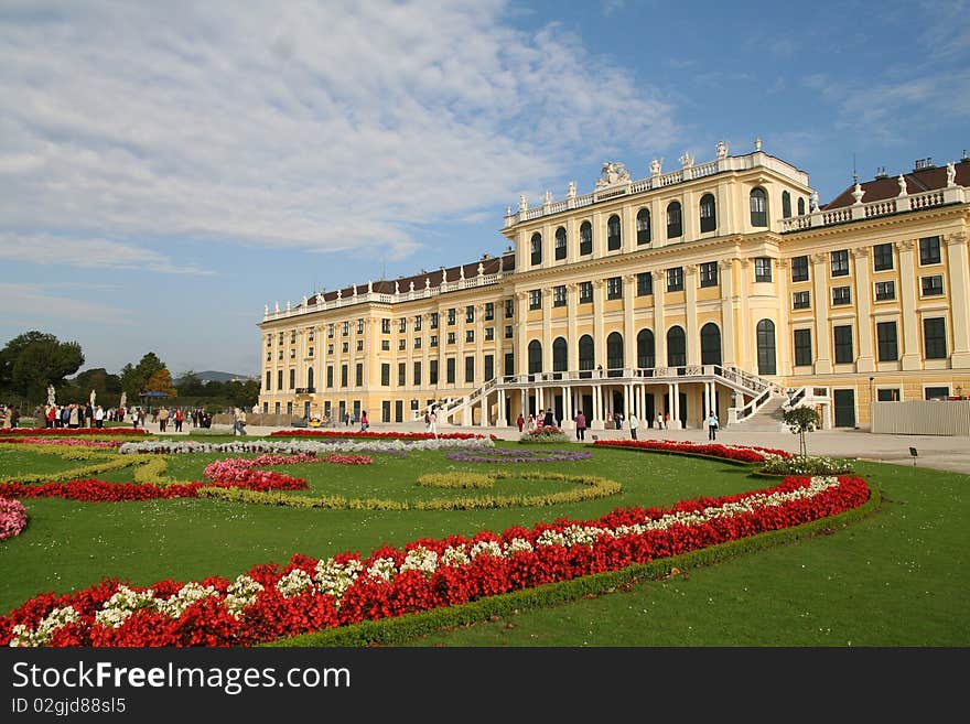 A corner view of magnificent Schoenbrunn Palace with three Primary colors - Red flowers, Green meadow and Blue sky. A corner view of magnificent Schoenbrunn Palace with three Primary colors - Red flowers, Green meadow and Blue sky