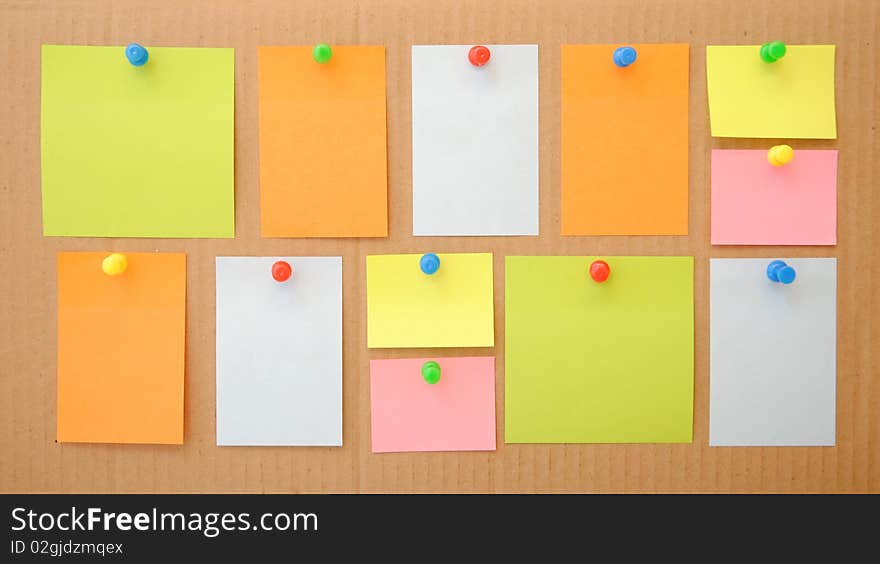 Colorful empty notes over brown cardboard