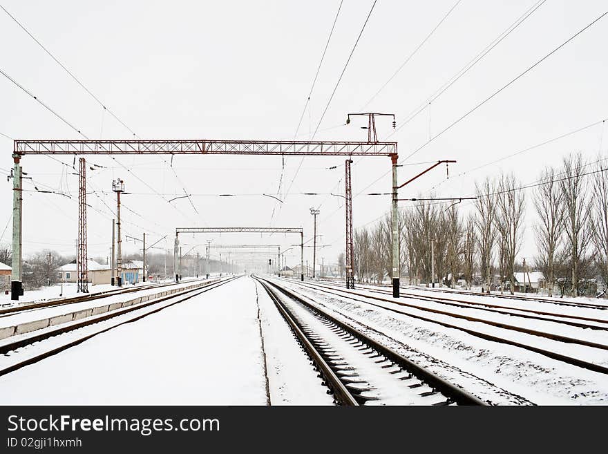 Snowy railways on railroad station in ukrainian village