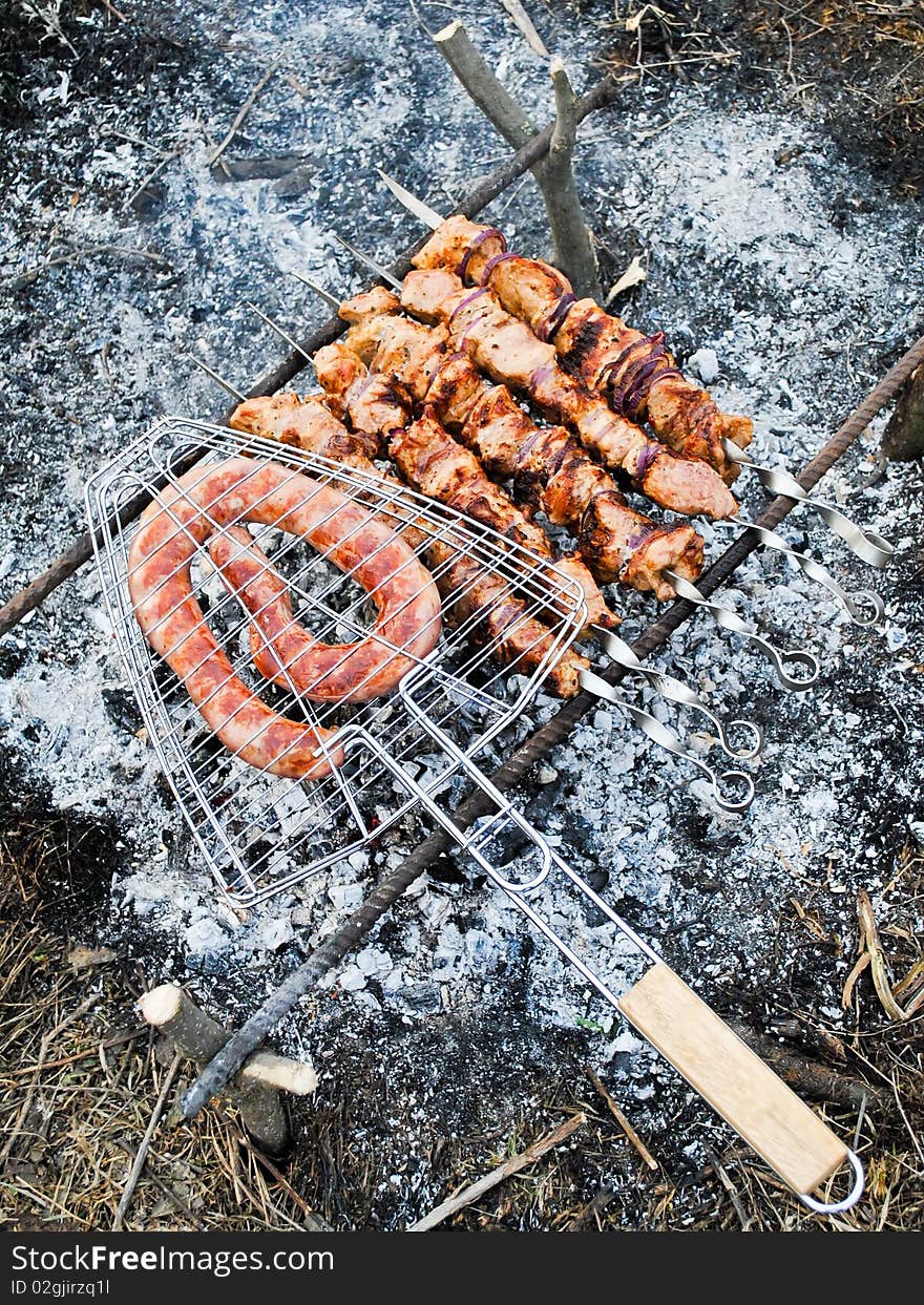 Shish kebab and sausage on fire