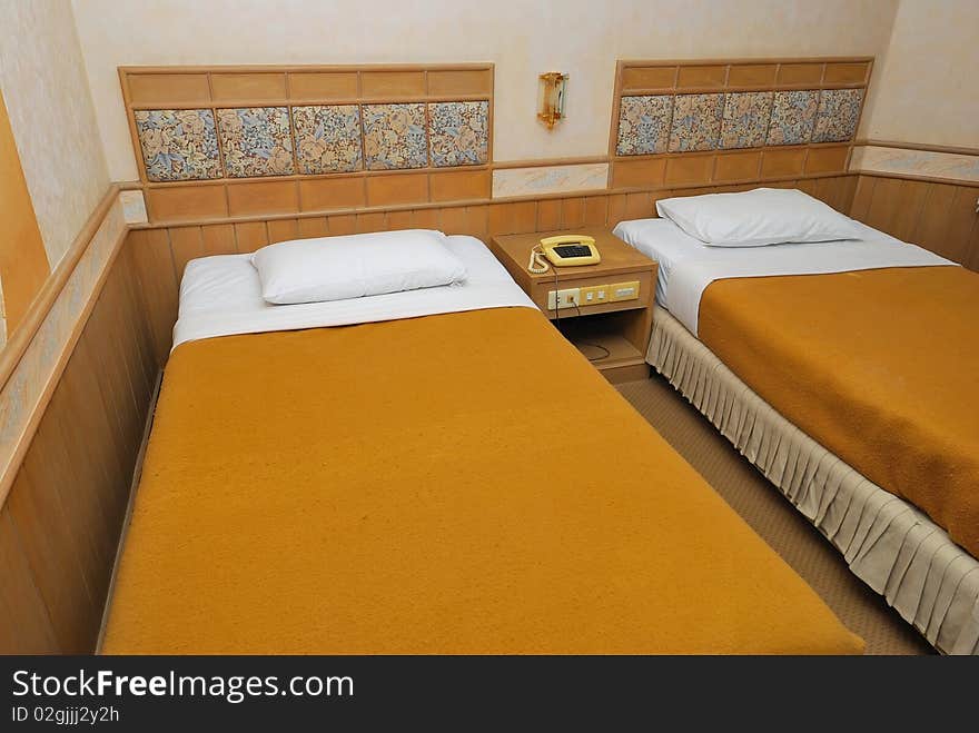 Twin beds in modern hotel room