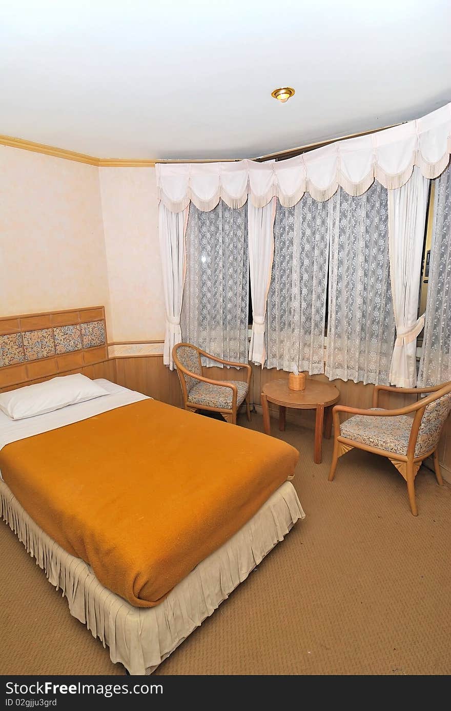 Single Bed In Hotel Room With Furniture