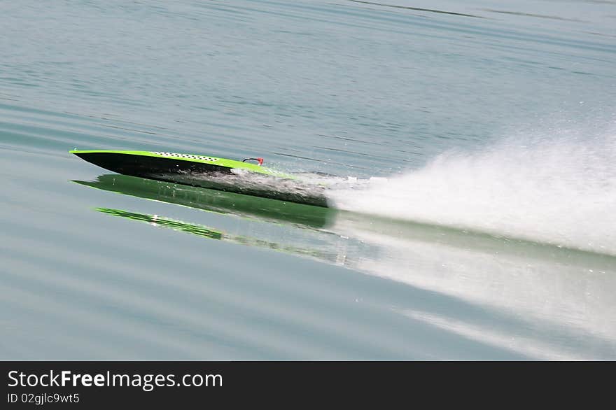 Remote control speedboat cutting through water at high speed. Fast, quick and responsive. Remote control speedboat cutting through water at high speed. Fast, quick and responsive.