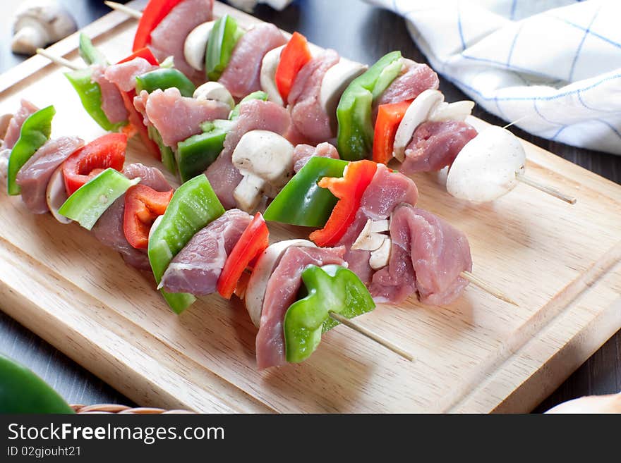 Oerhead shot of freshly made meatsticks on wooden bread board