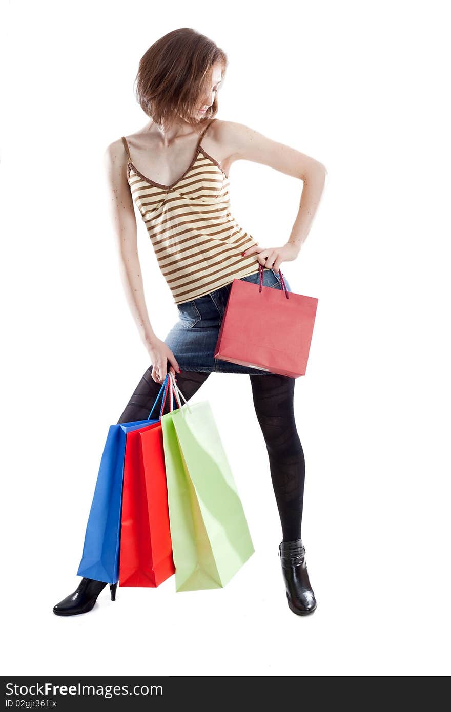 Sexy lady on white background with a lot of shopping bags in different color