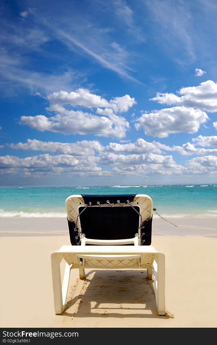 A sunbed near the water at exotic beach. Dominican Republic, Punta Cana.