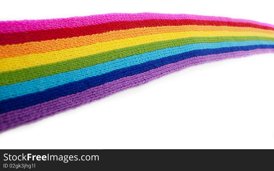 The image of a bright rainbow knitted scarf