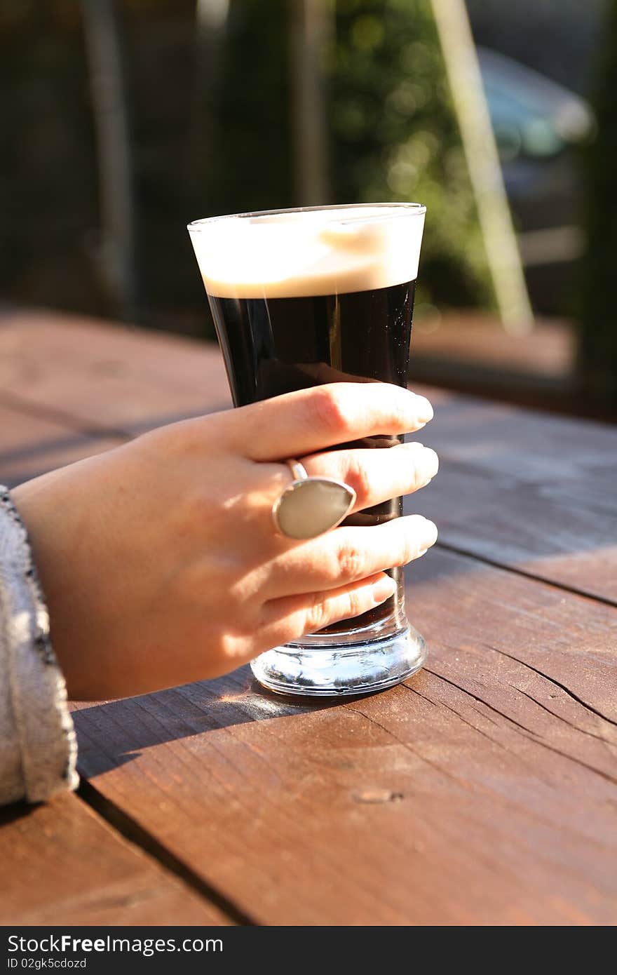 Glass of stout in a beer garden, Carlingford Ireland. Glass of stout in a beer garden, Carlingford Ireland